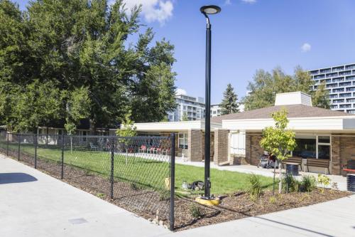 Renewed front landscape area with planting buffers to reduce unwanted circulation towards the building. New light post and LED luminaire casting light downwards reducing light pollution