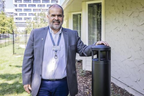 Jairo Rodriguez, Project Manager with the Silvera Capital Maintenance and Renewals team, standing beside one of the new light bollards illuminating the west side of the building, its design will allow for directional lighting reducing the casting of light into the residents’ windows at night.