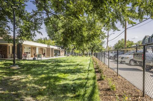 Another view of the renewed private front landscape area with planting buffers to reduce unwanted circulation towards the building. New light post and LED luminaire casting light downwards reducing light pollution.